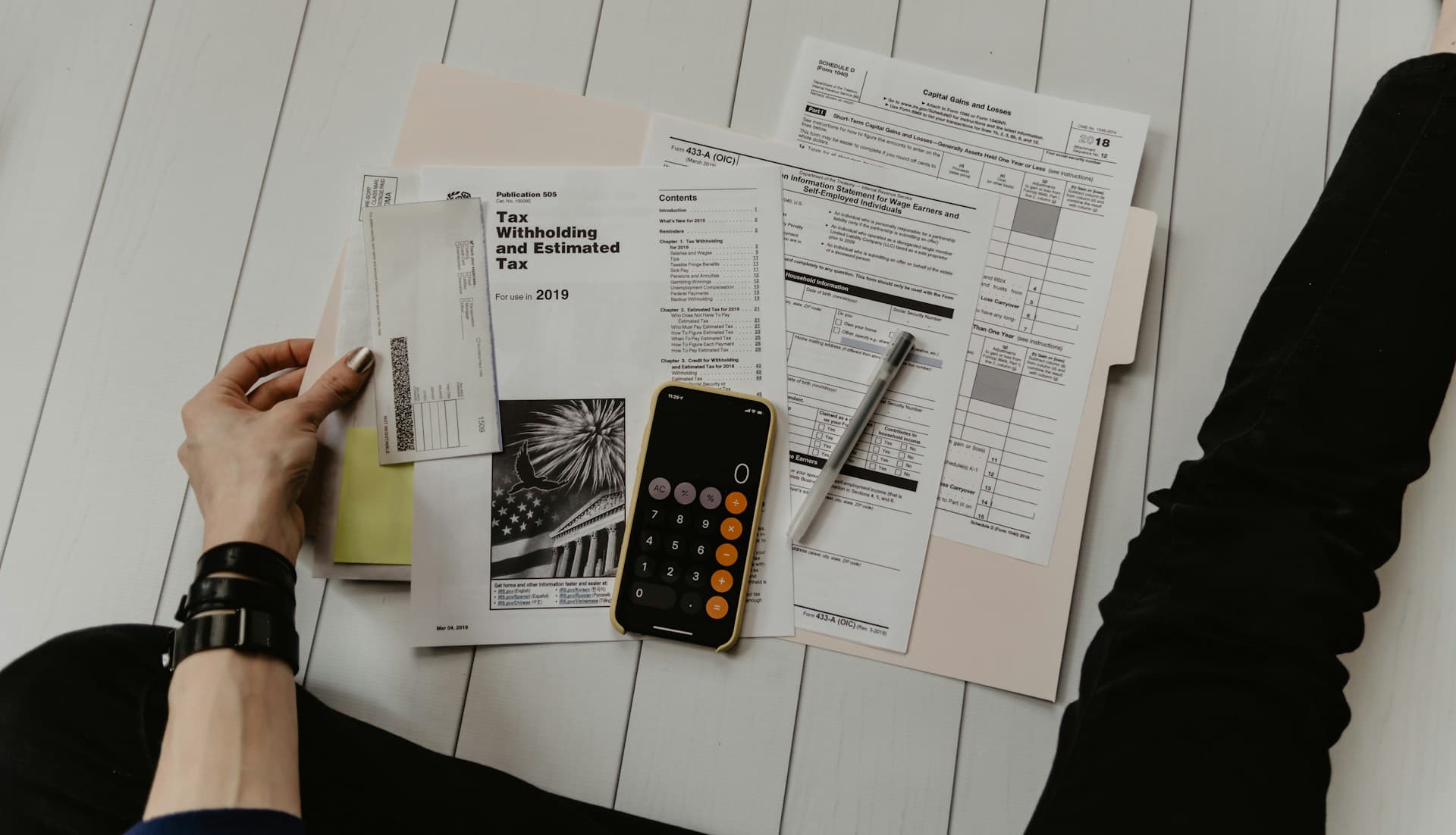 Tax documents, notice paperwork, calculator, and pen for audit and tax letter support.